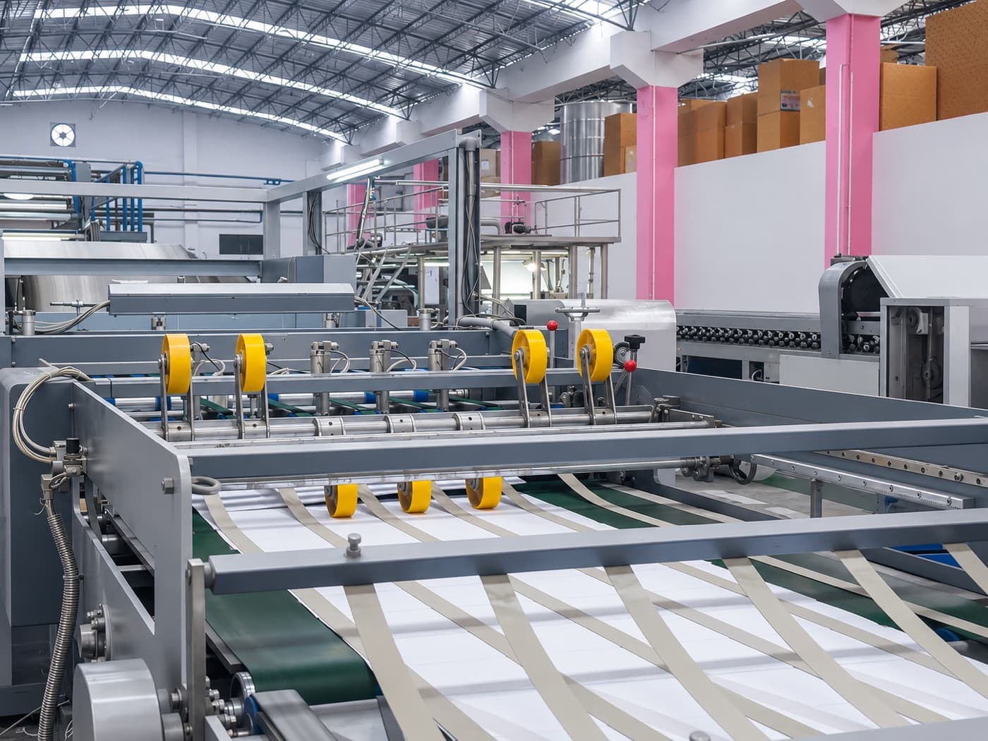 White paper web running through a slitting line